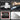 Set of tools including a gauge, wrench, punch and chisel set, and rods on a black background.