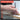 Hand holding a punch and chisel set with product features listed on a gray background