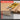 Two yellow utility knives on cardboard with feature list overlay