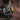 Close-up of a hand holding a flashlight near a mechanical component.