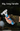 Multifunctional tool with a long handle held by a person wearing gloves.
