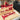 Red woodworking tools set on a wooden surface with a black carrying case.