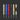 Set of six metal tools with different colored handles on a dark background