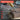 Punch tool marking wood with text highlighting features on a blurred workshop background