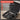 A cordless drill or screwdriver shown open in a black protective case, with a red and white 'Characteristics' text overlay listing features such as perfect for drilling and screwing, smart HD display, brushless motor, and complete bit set included.
