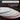 A stack of white circular polishing pads with colored edges in blue, yellow, and red, shown under a banner reading 'PRO-GRADE POLISHING' with text stating it is a complete kit for polishing granite, quartz, marble, glass, and other stone surfaces.
