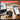 Digital tape measure with smartphone app connectivity on a desk setup.