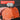 Orange tool with replaceable grinding wheels held by a hand against a black background.