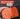 Orange tool with replaceable grinding wheels held by a hand against a black background.