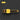 Yellow grill brush with black bristles on a dark background