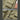 Close-up of a khaki vest with a chest pocket and front zipper on a wooden surface.
