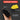 A hand holds a black textured foam tool with a yellow edge in front of a dark gray graphic background. White text callouts read 'HOOK AND LOOP BACKING,' 'DURABLE PU FOAM CONSTRUCTION,' and 'IDEAL FOR LONG-TERM USE IN METALWORKING AND DIY APPLICATIONS,' with a red header that says 'SUPERIOR CONTROL.