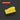 A bright yellow rectangular foam-like block with rounded top edges, shown on a dark gray background with subtle concentric circular lines. A red label at top left reads “SQUARE 2.