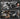 Product being used for cleaning a keyboard, car air vent, record player, and computer components on a dark background.