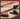 A cordless tri-tip sanding attachment shown on a wooden surface with sanding discs attached, plus marketing text that reads 'PREMIUM SANDING POWER' and 'INDUSTRIAL-GRADE CHROME AND PU BACKING BUILT TO SURVIVE HIGH-VIBRATION SANDING.'.