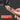 Hand holding a tool with an orange handle, labeled 'Perfect Contour in Seconds', on a dark background.