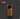Three yellow markers with gray caps in an orange holder on a dark background