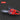 Red chainsaw on a black background with 'CHAINSAW' label.