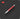 Red pen with silver accents on a black background