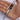 Metal tool held in a hand against a white background