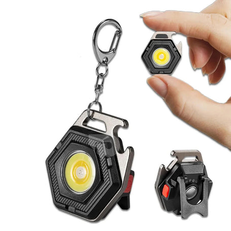 Mini keychain flashlight with carabiner and bottle opener on a white background
