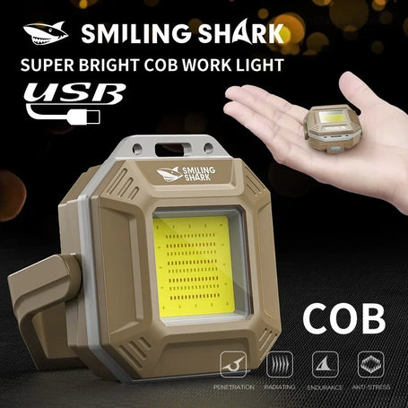 Smiling Shark super bright COB work light with USB connection on a dark background
