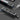 Dark gray precision screwdriver set with a press-to-open case, revealing neatly arranged magnetic bits and a retractable handle for easy access.