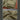 Khaki vest with bottom pocket and mesh fabric close-up.