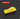 A bright yellow rectangular tool with a curved top handle, shown on a dark gray background with subtle concentric circle lines. A red label at the top left reads 'SQUARE 2.