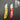 Two utility knives with yellow and red handles on a dark gray background
