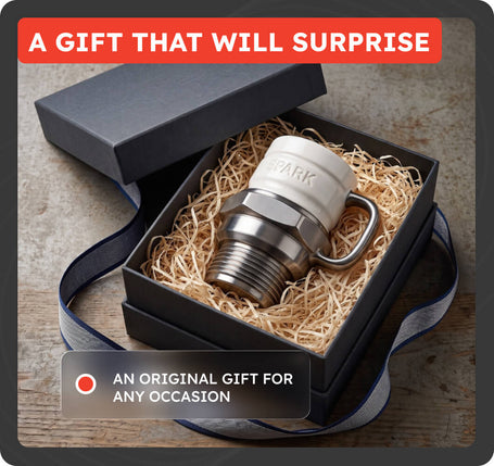A surprise gift set featuring a novelty faucet-shaped mug with a white ceramic top and a stainless steel threaded base, presented inside a black gift box filled with shredded paper. The image includes promotional text overlays reading 'A GIFT THAT WILL SURPRISE' and 'AN ORIGINAL GIFT FOR ANY OCCASION'.